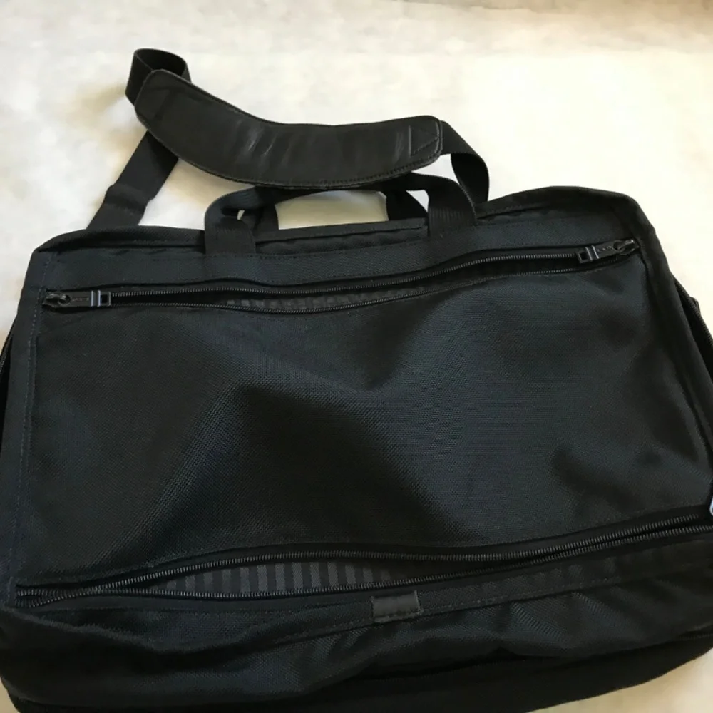Tumi Black expandable laptop bag. clean interior. Work, travel, Classic